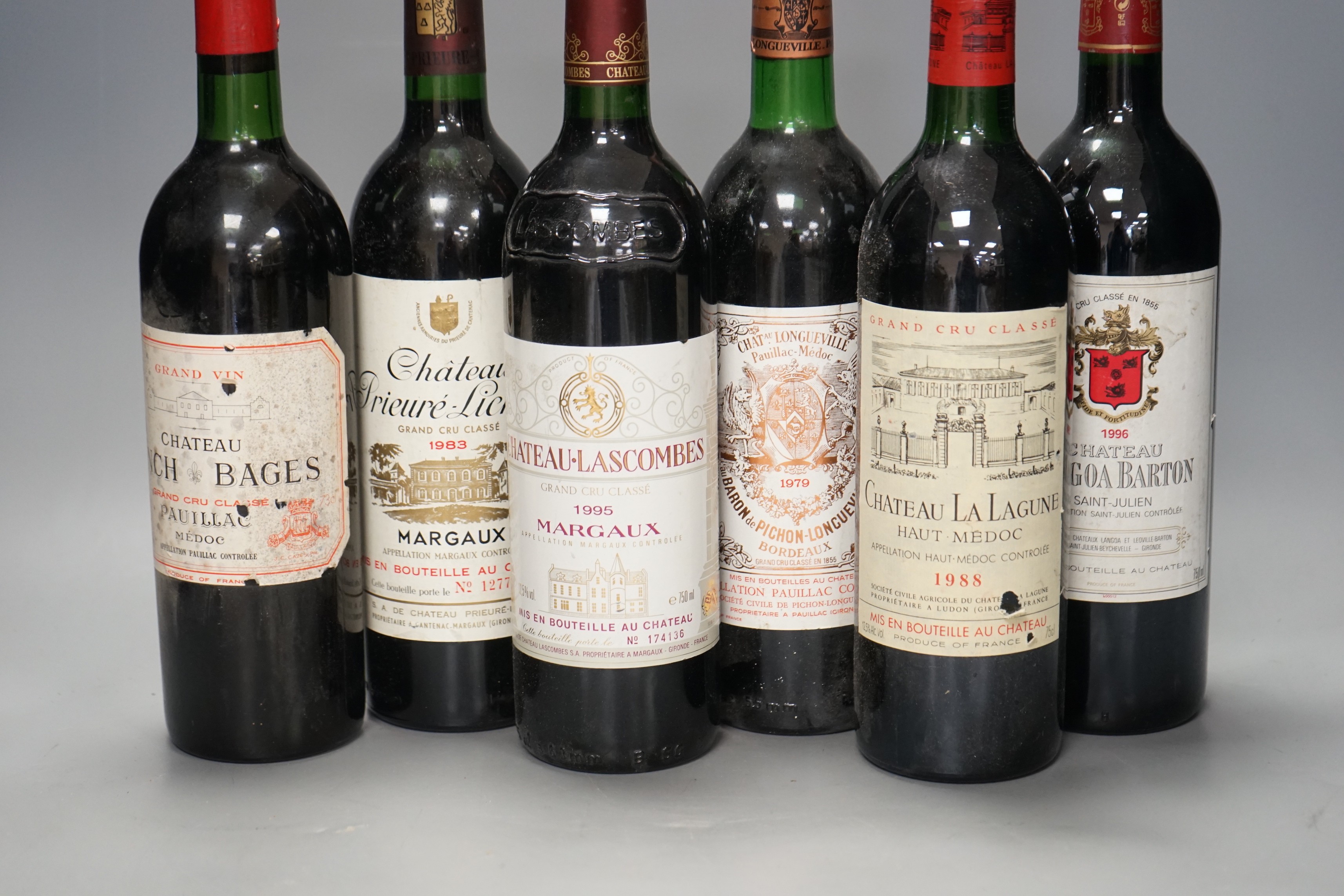 Six bottles of wine: Chateau Longville Pauillac Medoc 1979, Chateau Lascombes Margaux 1979, Chateau Lynch Bages Pauillac 1975, Chateau La Lagune Medoc 1988, Chateau Langoa Barton Saint-Julien 1996 and Chateau Prieure-Lic